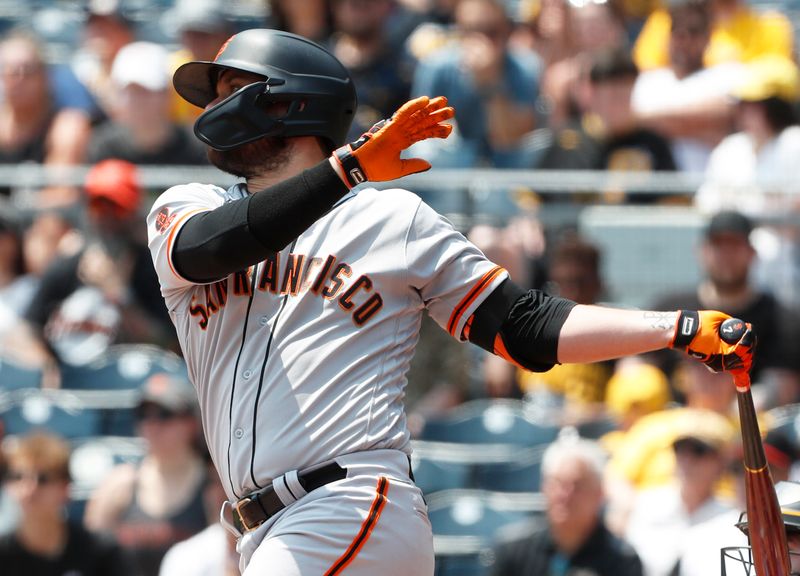 Jul 16, 2023; Pittsburgh, Pennsylvania, USA; San Francisco Giants third baseman J.D. Davis (7) hits an RBI single against the Pittsburgh Pirates during the third inning at PNC Park. Mandatory Credit: Charles LeClaire-USA TODAY Sports