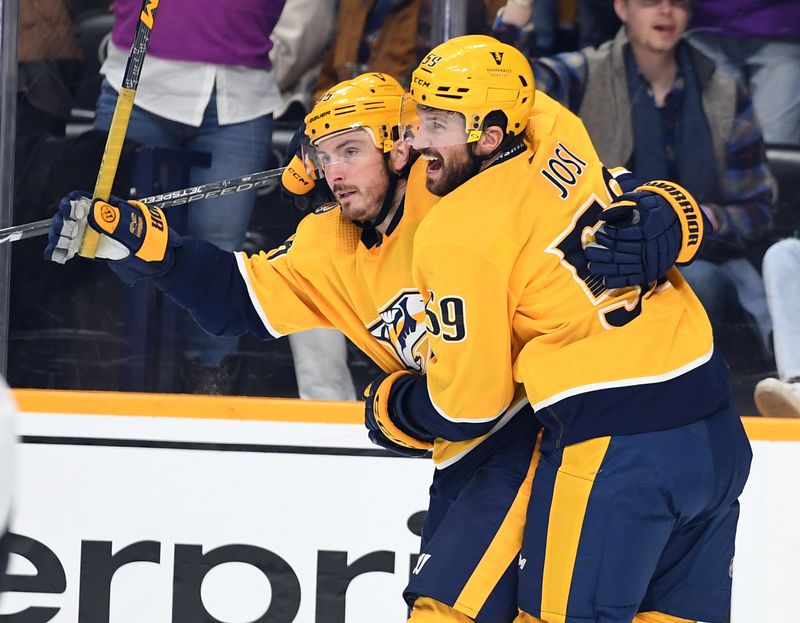 Jan 26, 2023; Nashville, Tennessee, USA; Nashville Predators center Matt Duchene (95) celebrates with defenseman Roman Josi (59) after a goal during the third period against the New Jersey Devils at Bridgestone Arena. Mandatory Credit: Christopher Hanewinckel-USA TODAY Sports