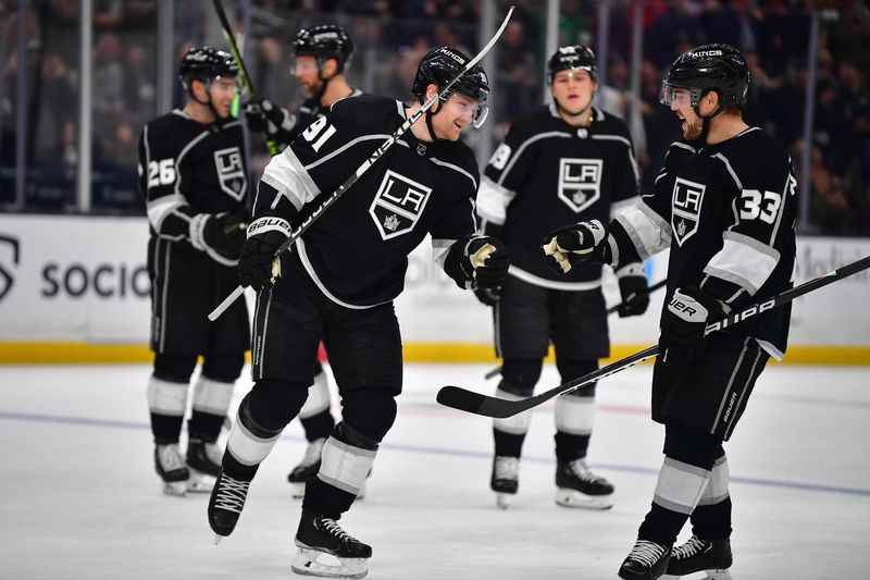 Mar 16, 2023; Los Angeles, California, USA; Los Angeles Kings right wing Carl Grundstrom (91) celebrates his goal scored against the Columbus Blue Jackets with right wing Viktor Arvidsson (33) during the second period at Crypto.com Arena. Mandatory Credit: Gary A. Vasquez-USA TODAY Sports