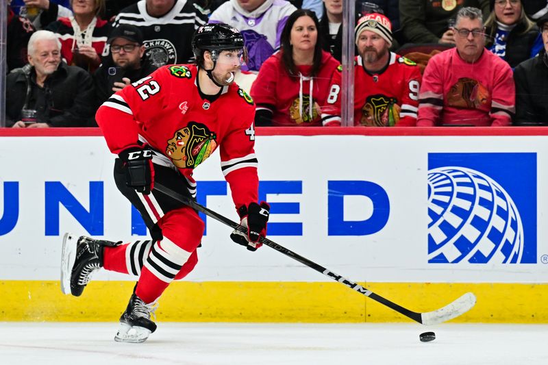 Jan 24, 2025; Chicago, Illinois, USA; Chicago Blackhawks defenseman Nolan Allan (42) skates with the puck against the Tampa Bay Lightning during the second period at the United Center. Mandatory Credit: Daniel Bartel-Imagn Images