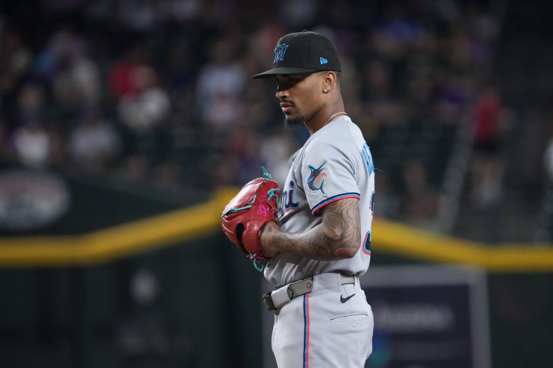 Jun 29, 2025; Phoenix, Arizona, USA; Miami Marlins pitcher Ronny Henriquez (32) pitches against the Arizona Diamondbacks during the ninth inning at Chase Field. Mandatory Credit: Joe Camporeale-Imagn Images