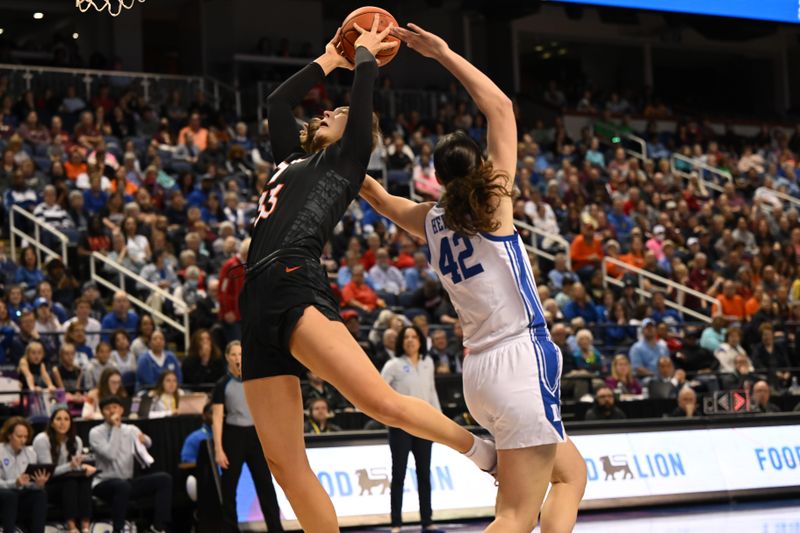 Mar 4, 2023; Greensboro, NC, USA; Virginia Tech Hokies center Elizabeth Kitley (33) battles for an inbounds pass against Duke Blue Devils forward Mia Heide (42) during the first half at Greensboro Coliseum. Mandatory Credit: William Howard-USA TODAY Sports