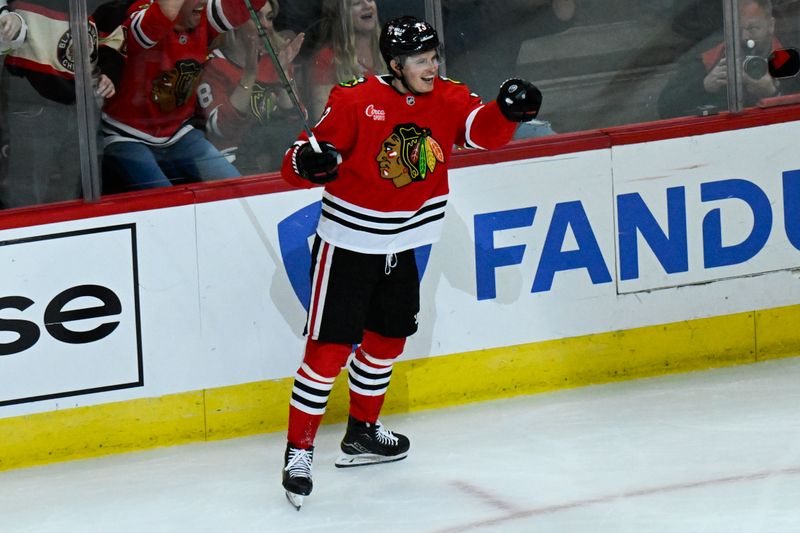 Oct 19, 2024; Chicago, Illinois, USA;  Chicago Blackhawks left wing Lukas Reichel (73) yells after assisting center Craig Smith (not pictured) on a goal during the second period against the Buffalo Sabres at the United Center. Mandatory Credit: Matt Marton-Imagn Images