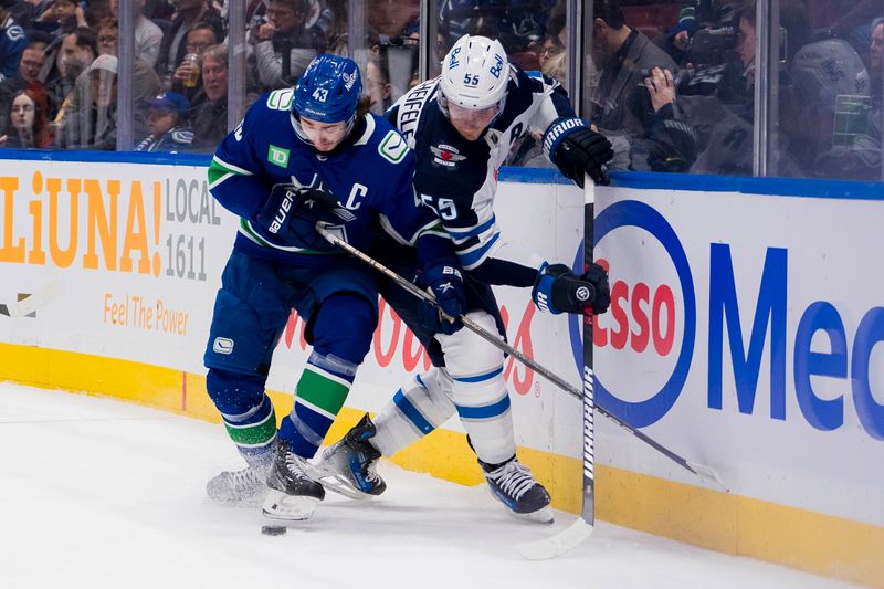 Mar 9, 2024; Vancouver, British Columbia, CAN; Vancouver Canucks defenseman Quinn Hughes (43) battles with Winnipeg Jets forward Mark Scheifele (55) in the first period at Rogers Arena. Mandatory Credit: Bob Frid-USA TODAY Sports