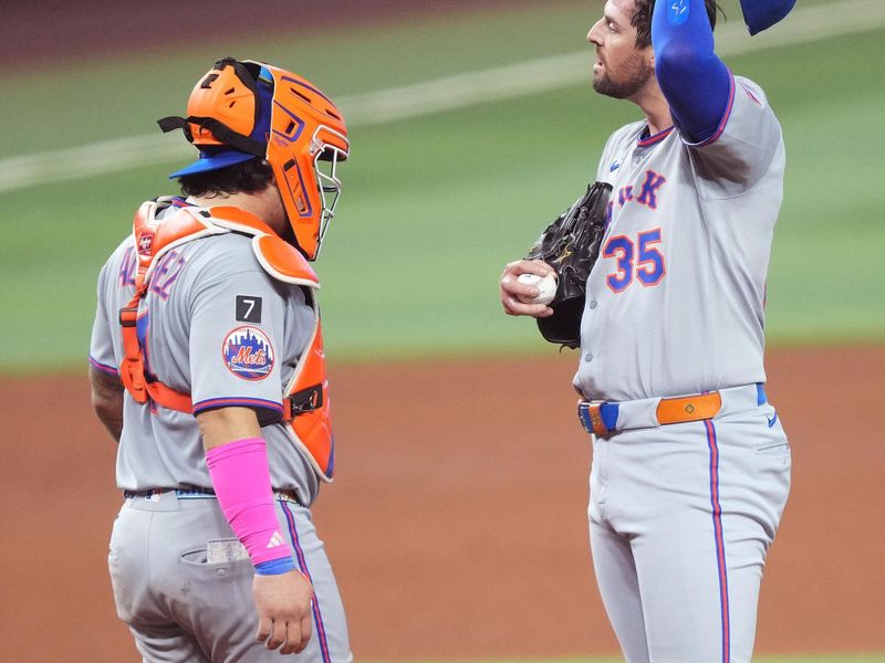 Sep 27, 2025; Miami, Florida, USA;  New York Mets pitcher Clay Holmes (35) gets a visit to the mound from catcher Francisco Alvarez (4) in the fifth inning against the Miami Marlins at loanDepot Park. Mandatory Credit: Jim Rassol-Imagn Images