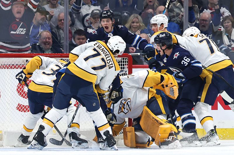 Jan 7, 2025; Winnipeg, Manitoba, CAN; Winnipeg Jets center Morgan Barron (36) celebrates his first period goal on Nashville Predators goaltender Juuse Saros (74) at Canada Life Centre. Mandatory Credit: James Carey Lauder-Imagn Images