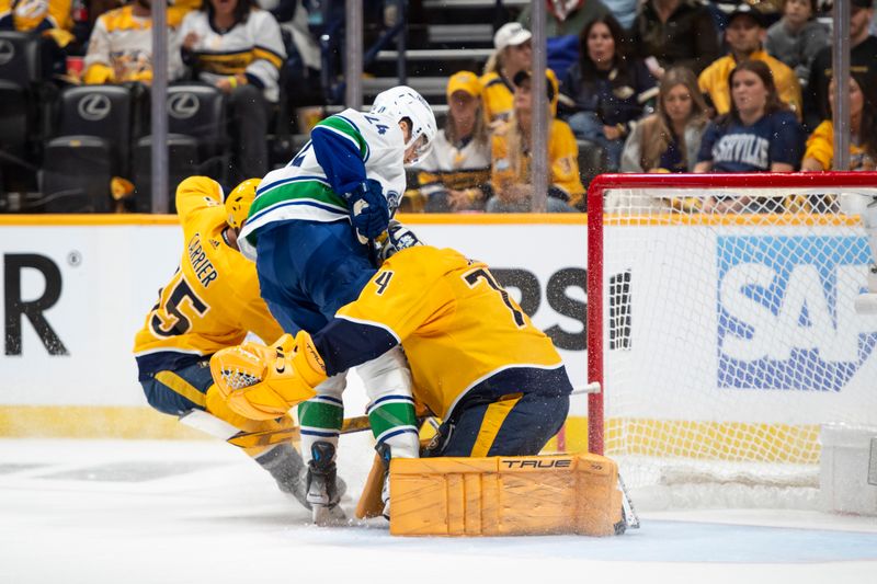 May 3, 2024; Nashville, Tennessee, USA; Nashville Predators goaltender Juuse Saros (74) blocks the shot of Vancouver Canucks center Pius Suter (24) during the second period in game six of the first round of the 2024 Stanley Cup Playoffs at Bridgestone Arena. Mandatory Credit: Steve Roberts-USA TODAY Sports