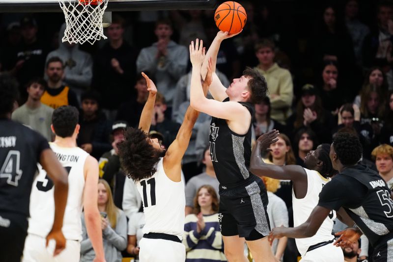 Jan 15, 2025; Boulder, Colorado, USA; Colorado Buffaloes forward Nick Randall (41) shoots over Colorado Buffaloes guard Javon Ruffin (11) in the second half at the CU Events Center. Mandatory Credit: Ron Chenoy-Imagn Images