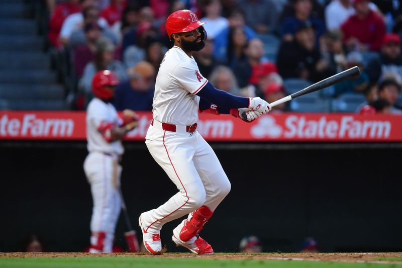 Apr 23, 2024; Anaheim, California, USA; Los Angeles Angels right fielder Jo Adell (7) hits an RBI single against the Baltimore Orioles during the third inning at Angel Stadium. Mandatory Credit: Gary A. Vasquez-USA TODAY Sports