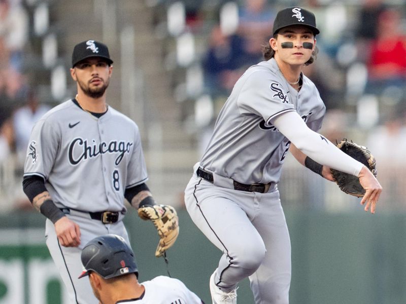 Apr 23, 2025; Minneapolis, Minnesota, USA; Chicago White Sox second base Brooks Baldwin (27) completes the double play off a ball hit by Minnesota Twins shortstop Carlos Correa (4) in the third inning at Target Field. Mandatory Credit: Matt Blewett-Imagn Images