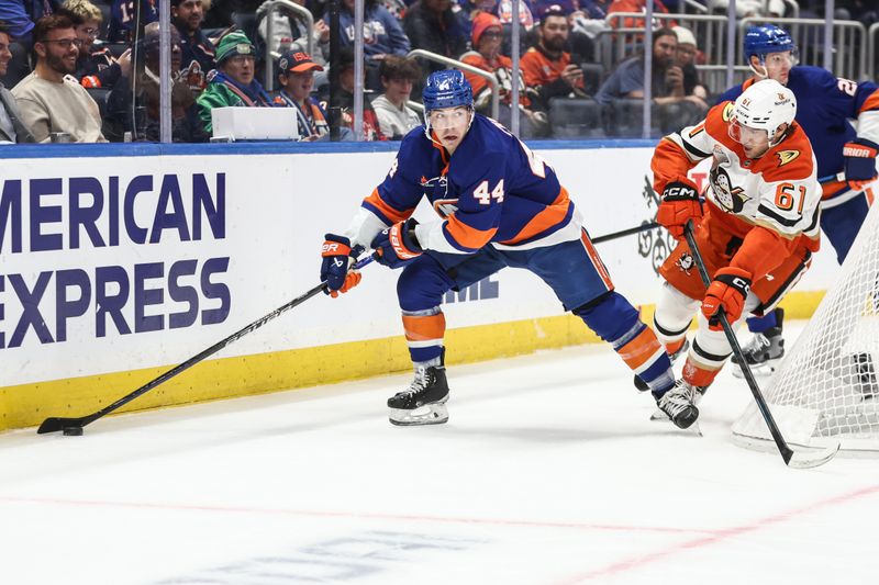 Oct 29, 2024; Elmont, New York, USA; New York Islanders center Jean-Gabriel Pageau (44) and Anaheim Ducks left wing Cutter Gauthier (61) battle for control of the puck in the first period at UBS Arena. Mandatory Credit: Wendell Cruz-Imagn Images