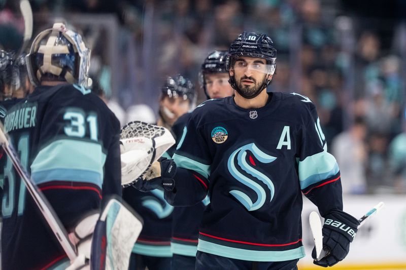 Jan 21, 2026; Seattle, Washington, USA; Seattle Kraken forward Matty Beniers (10) is congratulated by teammates on the bench after scoring a goal during the first period against the New York Islanders at Climate Pledge Arena. Mandatory Credit: Stephen Brashear-Imagn Images