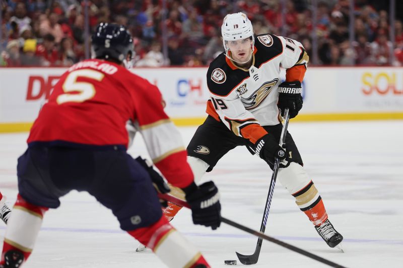 Jan 15, 2024; Sunrise, Florida, USA; Anaheim Ducks right wing Troy Terry (19) moves the puck as Florida Panthers defenseman Aaron Ekblad (5) defends during the first period at Amerant Bank Arena. Mandatory Credit: Sam Navarro-USA TODAY Sports