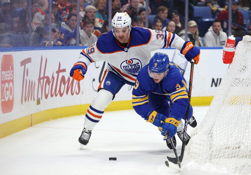 Mar 9, 2024; Buffalo, New York, USA;  Edmonton Oilers center Sam Carrick (39) watches as Buffalo Sabres left wing Zach Benson (9) falls going after a loose puck during the second period at KeyBank Center. Mandatory Credit: Timothy T. Ludwig-USA TODAY Sports