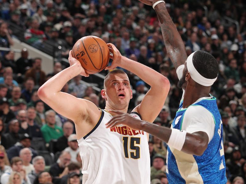 MILWAUKEE, WI - FEBRUARY 12: Nikola Jokic #15 of the Denver Nuggets shoots the ball during the game against the Milwaukee Bucks on February 12, 2024 at the Fiserv Forum Center in Milwaukee, Wisconsin. NOTE TO USER: User expressly acknowledges and agrees that, by downloading and or using this Photograph, user is consenting to the terms and conditions of the Getty Images License Agreement. Mandatory Copyright Notice: Copyright 2024 NBAE (Photo by Gary Dineen/NBAE via Getty Images).