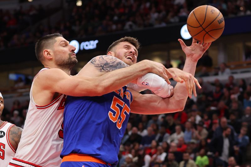 CHICAGO, ILLINOIS - APRIL 09: Nikola Vucevic #9 of the Chicago Bulls fouls Isaiah Hartenstein #55 of the New York Knicks during the first half at the United Center on April 09, 2024 in Chicago, Illinois. NOTE TO USER: User expressly acknowledges and agrees that, by downloading and or using this photograph, User is consenting to the terms and conditions of the Getty Images License Agreement.  (Photo by Michael Reaves/Getty Images)