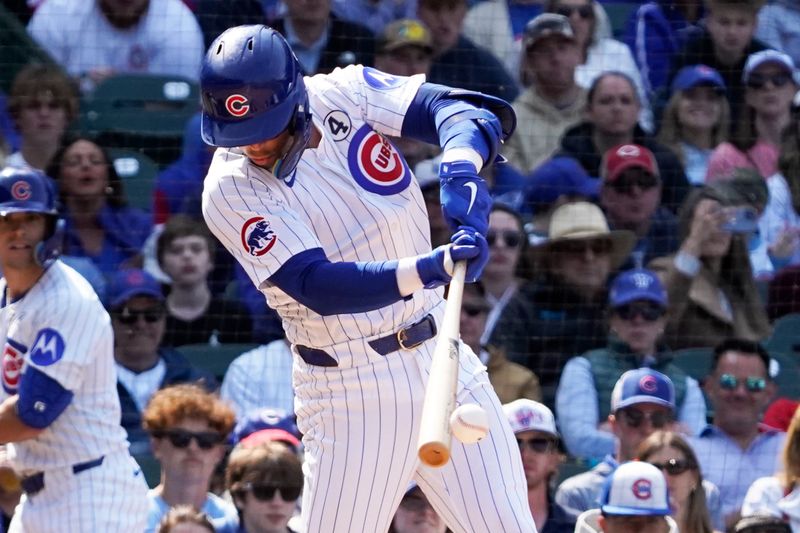 Jun 1, 2025; Chicago, Illinois, USA; Chicago Cubs second base Nico Hoerner (2) hits a two-run single against the Cincinnati Reds during the seventh inning at Wrigley Field. Mandatory Credit: David Banks-Imagn Images