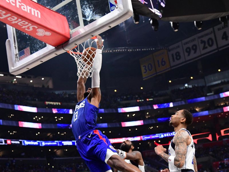 LOS ANGELES, CA - APRIL 21:  Paul George #13 of the LA Clippers dunks the ball again the Dallas Mavericks during Round 1 Game 1 of the 2024 NBA Playoffs on April 21, 2024 at Crypto.Com Arena in Los Angeles, California. NOTE TO USER: User expressly acknowledges and agrees that, by downloading and/or using this Photograph, user is consenting to the terms and conditions of the Getty Images License Agreement. Mandatory Copyright Notice: Copyright 2024 NBAE (Photo by Adam Pantozzi/NBAE via Getty Images)