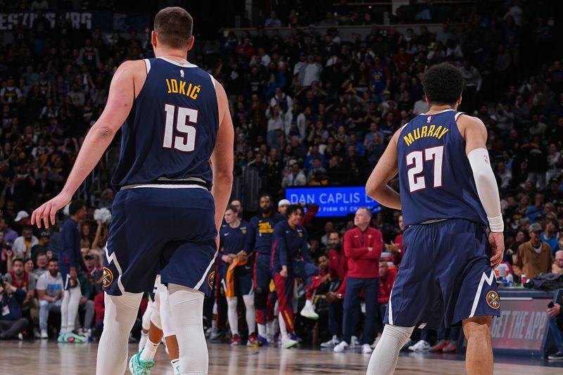 DENVER, CO - APRIL 10: Nikola Jokic #15 and Jamal Murray #27 of the Denver Nuggets look on during the game against the Minnesota Timberwolves  on April 10, 2024 at the Ball Arena in Denver, Colorado. NOTE TO USER: User expressly acknowledges and agrees that, by downloading and/or using this Photograph, user is consenting to the terms and conditions of the Getty Images License Agreement. Mandatory Copyright Notice: Copyright 2024 NBAE (Photo by Bart Young/NBAE via Getty Images)