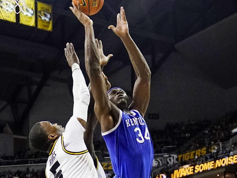 Dec 28, 2022; Columbia, Missouri, USA; Kentucky Wildcats forward Oscar Tshiebwe (34) shoots against Missouri Tigers guard D'Moi Hodge (5) during the first half at Mizzou Arena. Mandatory Credit: Jay Biggerstaff-USA TODAY Sports