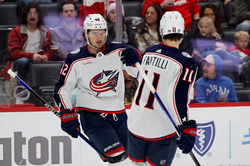 Nov 11, 2023; Detroit, Michigan, USA;  Columbus Blue Jackets center Alexandre Texier (42) celebrates with center Adam Fantilli (11) after scoring against the Detroit Red Wings in the first period  at Little Caesars Arena. Mandatory Credit: Rick Osentoski-USA TODAY Sports