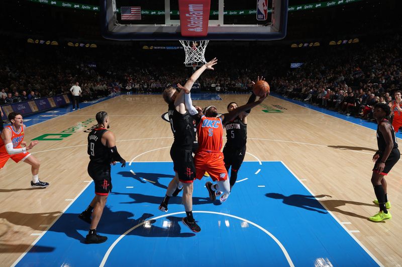 OKLAHOMA CITY, OK - MARCH 27:  Luguentz Dort #5 of the Oklahoma City Thunder grabs a rebound during the game against the Houston Rockets on March 27, 2024 at Paycom Arena in Oklahoma City, Oklahoma. NOTE TO USER: User expressly acknowledges and agrees that, by downloading and or using this photograph, User is consenting to the terms and conditions of the Getty Images License Agreement. Mandatory Copyright Notice: Copyright 2024 NBAE (Photo by Zach Beeker/NBAE via Getty Images)