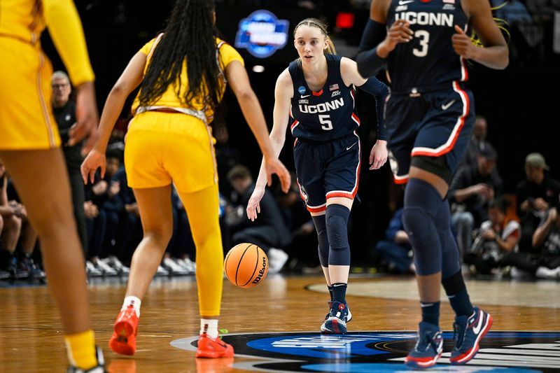 Apr 1, 2024; Portland, OR, USA; UConn Huskies guard Paige Bueckers (5) dribbles the basketball during the first half against the USC Trojans in the finals of the Portland Regional of the NCAA Tournament at the Moda Center. Mandatory Credit: Troy Wayrynen-USA TODAY Sports