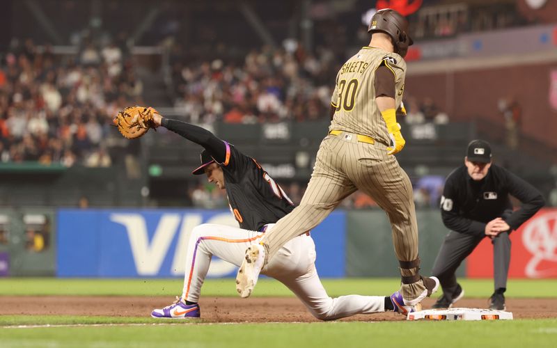Jun 3, 2025; San Francisco, California, USA;  San Francisco Giants first baseman Casey Schmitt (10) catches the ball for a double play against San Diego Padres designated hitter Gavin Sheets (30) during the eighth inning at Oracle Park. Mandatory Credit: Kelley L Cox-Imagn Images
