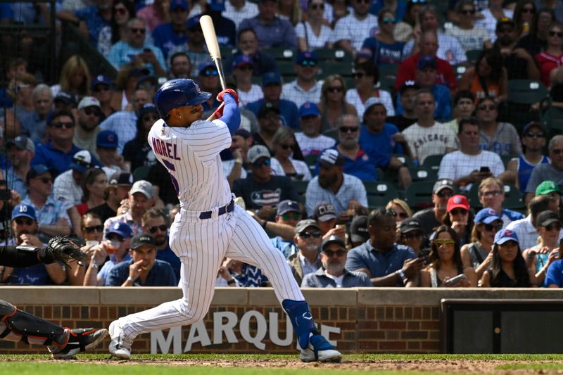 Sep 6, 2023; Chicago, Illinois, USA;  Chicago Cubs second baseman Christopher Morel (5) hits an RBI single during the sixth inning against the San Francisco Giants at Wrigley Field. Mandatory Credit: Matt Marton-USA TODAY Sports