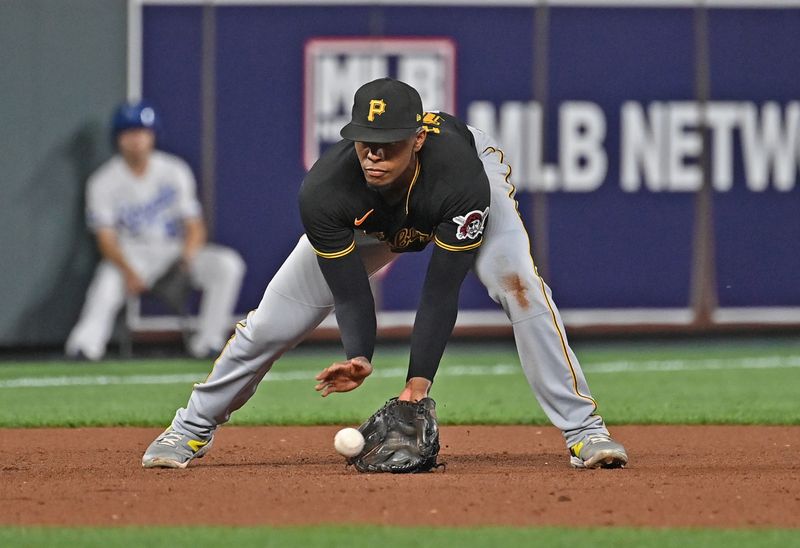 Aug 28, 2023; Kansas City, Missouri, USA;  Pittsburgh Pirates third baseman Ke'Bryan Hayes (13) fields a ground ball in the seventh inning against the Kansas City Royals at Kauffman Stadium. Mandatory Credit: Peter Aiken-USA TODAY Sports