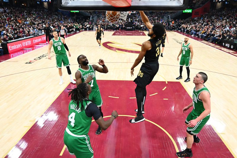 CLEVELAND, OHIO - FEBRUARY 04: Jarrett Allen #31 of the Cleveland Cavaliers dunks over Jrue Holiday #4 Jaylen Brown #7 and Payton Pritchard #11 of the Boston Celtics during the second quarter at Rocket Mortgage Fieldhouse on February 04, 2025 in Cleveland, Ohio. The Celtics defeated the Cavaliers 112-105. NOTE TO USER: User expressly acknowledges and agrees that, by downloading and or using this photograph, User is consenting to the terms and conditions of the Getty Images License Agreement. (Photo by Jason Miller/Getty Images)