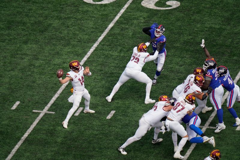 Washington Commanders quarterback Sam Howell (14) passes against the New York Giants during the second quarter an NFL football game, Sunday, Oct. 22, 2023, in East Rutherford, N.J. (AP Photo/Seth Wenig)