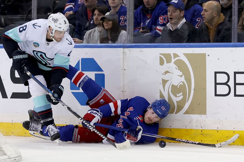 Jan 16, 2024; New York, New York, USA; New York Rangers left wing Alexis Lafreniere (13) and Seattle Kraken defenseman Brian Dumoulin (8) fight for the puck during the third period at Madison Square Garden. Mandatory Credit: Brad Penner-USA TODAY Sports