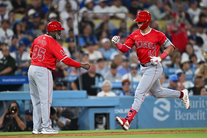 Jun 22, 2024; Los Angeles, California, USA; Los Angeles Angels catcher Logan O'Hoppe (14) celebrates with third base coach Eric Young Sr. (85) after hitting a home run against the Los Angeles Dodgers during the seventh inning at Dodger Stadium. Mandatory Credit: Jonathan Hui-USA TODAY Sports