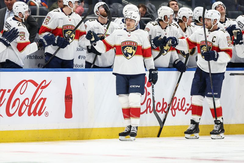 Mar 16, 2025; Elmont, New York, USA;  Florida Panthers center Sam Reinhart (13) celebrates with his teammates after scoring a goal in the second period against the New York Islanders at UBS Arena. Mandatory Credit: Wendell Cruz-Imagn Images
