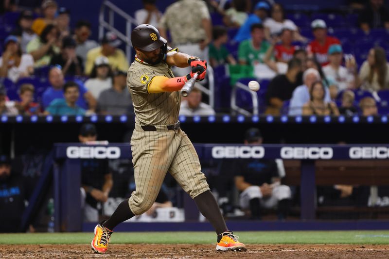 Aug 11, 2024; Miami, Florida, USA; San Diego Padres designated hitter Xander Bogaerts (2) hits a single against the Miami Marlins during the seventh inning at loanDepot Park. Mandatory Credit: Sam Navarro-USA TODAY Sports