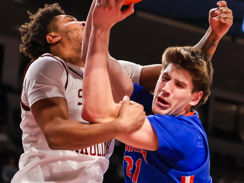 Jan 28, 2026; Columbia, South Carolina, USA; Florida Gators forward Alex Condon (21) is fouled by South Carolina Gamecocks forward Elijah Strong (31) in the second half at Colonial Life Arena. Mandatory Credit: Jeff Blake-Imagn Images