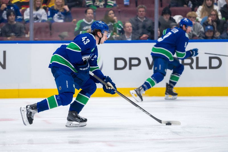 Jan 16, 2025; Vancouver, British Columbia, CAN; Vancouver Canucks defenseman Quinn Hughes (43) handles the puck against the Los Angeles Kings in the third period at Rogers Arena. Mandatory Credit: Bob Frid-Imagn Images