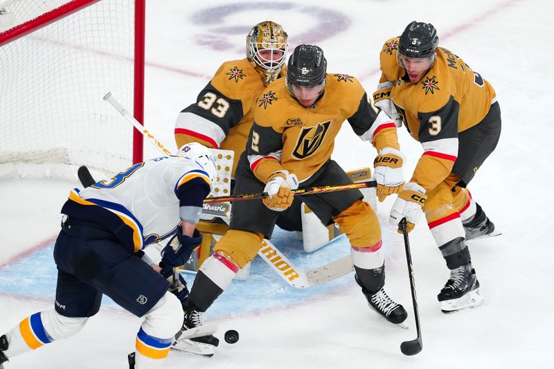 Oct 11, 2024; Las Vegas, Nevada, USA; Vegas Golden Knights defenseman Zach Whitecloud (2) and defenseman Brayden McNabb (3) attempt to block a shot attempt by St. Louis Blues left wing Jake Neighbours (63) during the third period at T-Mobile Arena. Mandatory Credit: Stephen R. Sylvanie-Imagn Images