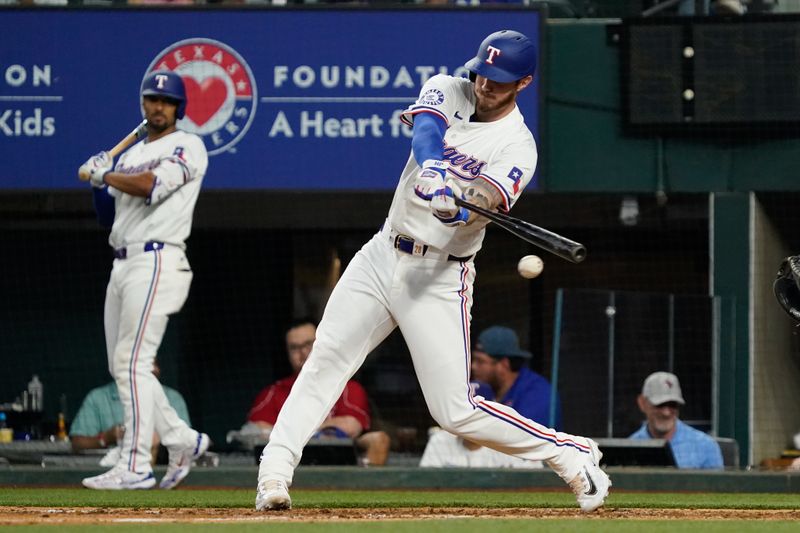 Apr 25, 2024; Arlington, Texas, USA; Texas Rangers catcher Jonah Heim (28) hits a single during the seventh inning Seattle Mariners at Globe Life Field. Mandatory Credit: Raymond Carlin III-USA TODAY Sports