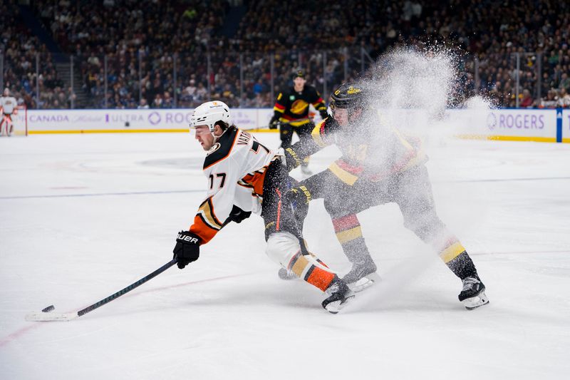 Nov 28, 2023; Vancouver, British Columbia, CAN; Vancouver Canucks defenseman Quinn Hughes (43) defends against Anaheim Ducks forward Frank Vatrano (77) in the third period at Rogers Arena. Vancouver won 3-1. Mandatory Credit: Bob Frid-USA TODAY Sports