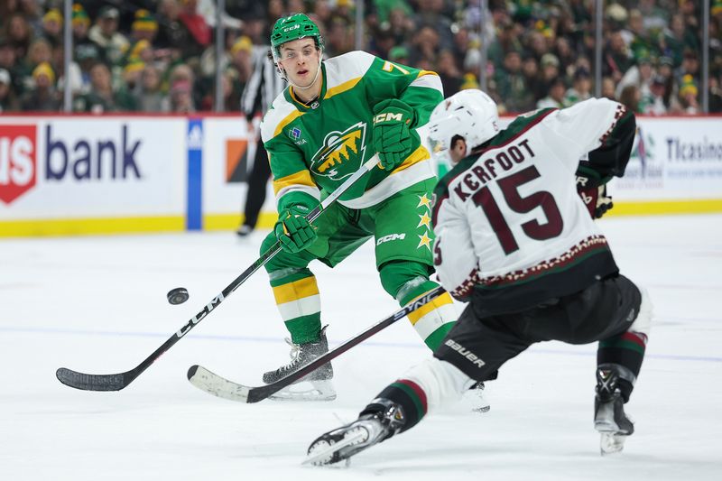 Jan 13, 2024; Saint Paul, Minnesota, USA; Minnesota Wild defenseman Brock Faber (7) passes as Arizona Coyotes center Alexander Kerfoot (15) defends during the second period at Xcel Energy Center. Mandatory Credit: Matt Krohn-USA TODAY Sports