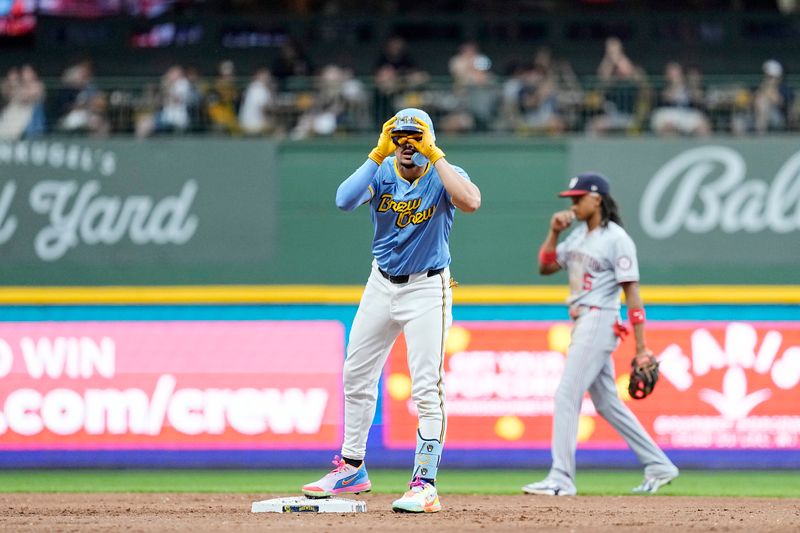 Jul 12, 2024; Milwaukee, Wisconsin, USA;  Milwaukee Brewers shortstop Willy Adames (27) celebrates at second base after hitting a double during the fourth inning against the Washington Nationals at American Family Field. Mandatory Credit: Jeff Hanisch-USA TODAY Sports