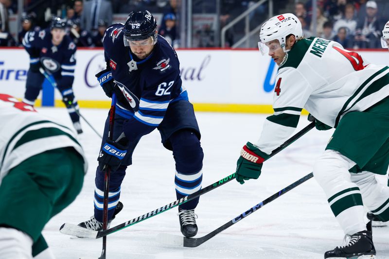 Oct 13, 2024; Winnipeg, Manitoba, CAN;  Winnipeg Jets forward Nino Niederreiter (62) and Minnesota Wild defenseman Jon Merrill (4) contest for the puck during the second period at Canada Life Centre. Mandatory Credit: Terrence Lee-Imagn Images