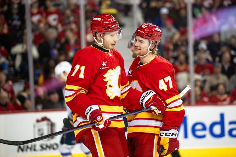 Dec 5, 2024; Calgary, Alberta, CAN; Calgary Flames right wing Walker Duehr (71) and center Connor Zary (47) laugh after a play against the St. Louis Blues during the second period at Scotiabank Saddledome. Mandatory Credit: Brett Holmes-Imagn Images