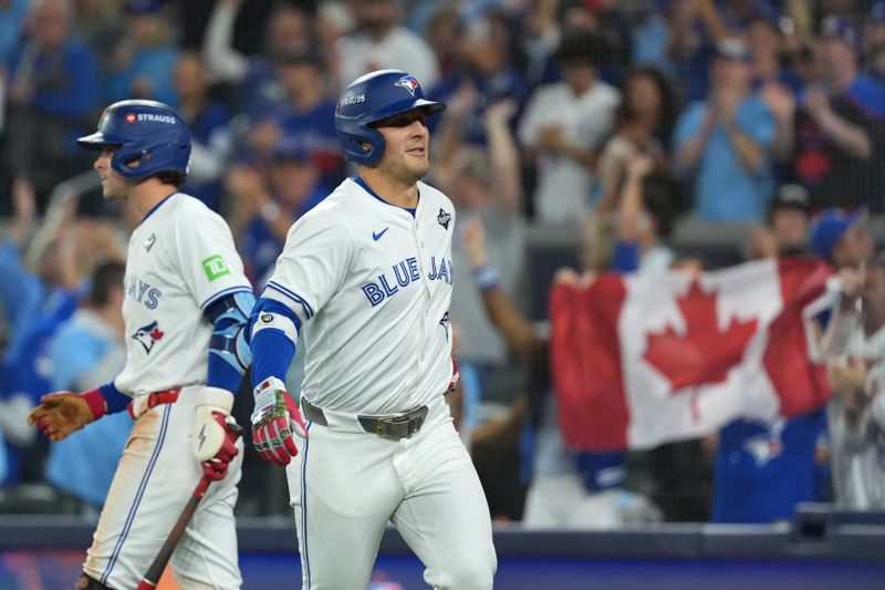 Oct 24, 2025; Toronto, Ontario, CAN; Toronto Blue Jays center fielder Daulton Varsho (5) celebrates after hitting a two run home run against the Los Angeles Dodgers in the fourth inning during game one of the 2025 MLB World Series at Rogers Centre. Mandatory Credit: Nick Turchiaro-Imagn Images
