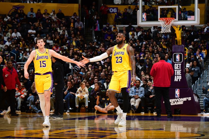 LOS ANGELES, CA - JANUARY 3: Austin Reaves #15 of the Los Angeles Lakers high-fives LeBron James #23 during the game against the Miami Heat on January 3, 2024 at Crypto.Com Arena in Los Angeles, California. NOTE TO USER: User expressly acknowledges and agrees that, by downloading and/or using this Photograph, user is consenting to the terms and conditions of the Getty Images License Agreement. Mandatory Copyright Notice: Copyright 2024 NBAE (Photo by Adam Pantozzi/NBAE via Getty Images)