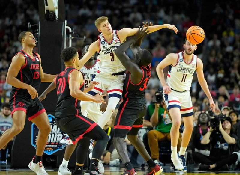 Apr 3, 2023; Houston, TX, USA; Connecticut Huskies guard Joey Calcaterra (3) blocks the shot of San Diego State Aztecs forward Aguek Arop (33) during the first half in the national championship game of the 2023 NCAA Tournament at NRG Stadium. Mandatory Credit: Bob Donnan-USA TODAY Sports