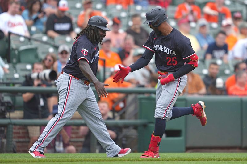 May 15, 2025; Baltimore, Maryland, USA; Minnesota Twins outfielder Byron Buxton (25) greeted by coach Tommy Watkins (40) following his solo home run during the third inning against the Baltimore Orioles at Oriole Park at Camden Yards. Mandatory Credit: Mitch Stringer-Imagn Images