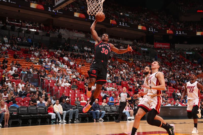 MIAMI, FL - APRIL 14:  Ochai Agbaji #30 of the Toronto Raptors goes to the basket during the game  on April 14, 2024 at Kaseya Center in Miami, Florida. NOTE TO USER: User expressly acknowledges and agrees that, by downloading and or using this Photograph, user is consenting to the terms and conditions of the Getty Images License Agreement. Mandatory Copyright Notice: Copyright 2024 NBAE (Photo by Issac Baldizon/NBAE via Getty Images)